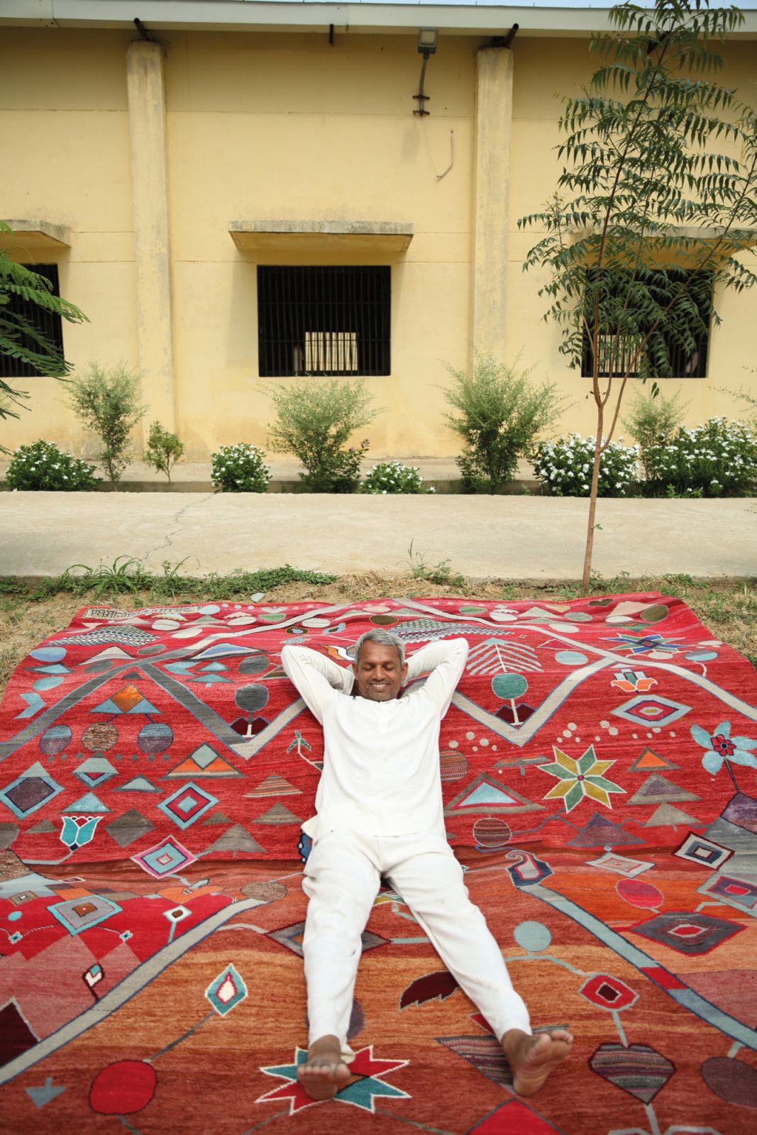 Another one of the Jaipur Rugs artisan weavers, posing with his creation