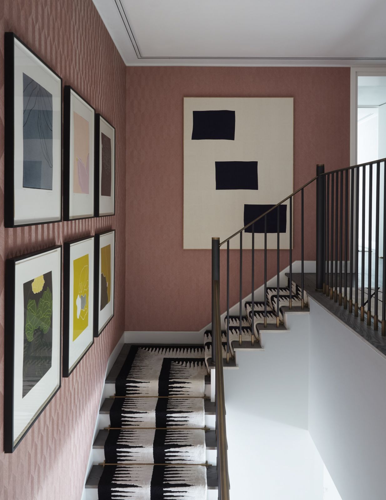 The rich raspberry textured wall covering in the hallway