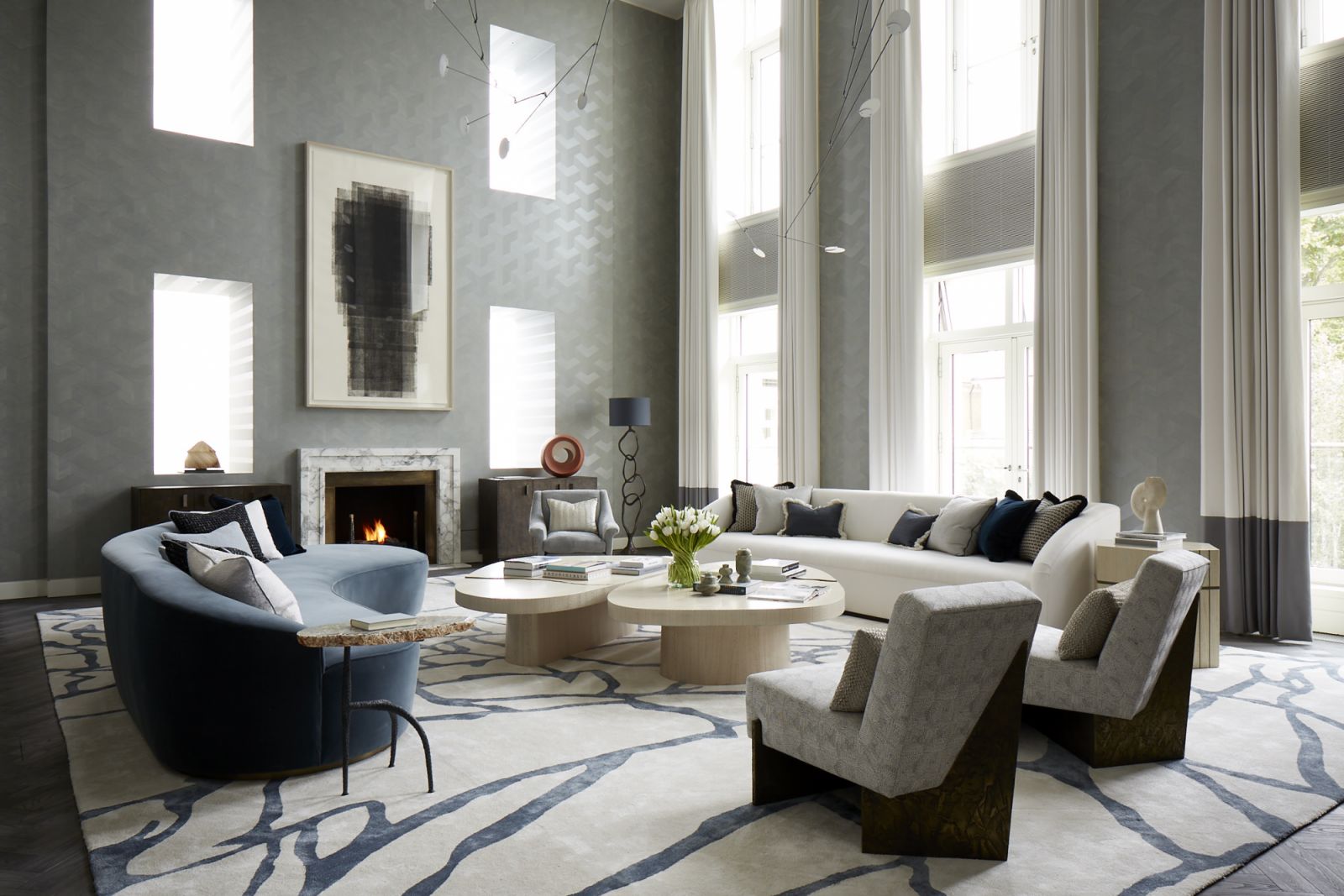 Hand-painted walls resembling chevron marquetry in the double-height living room