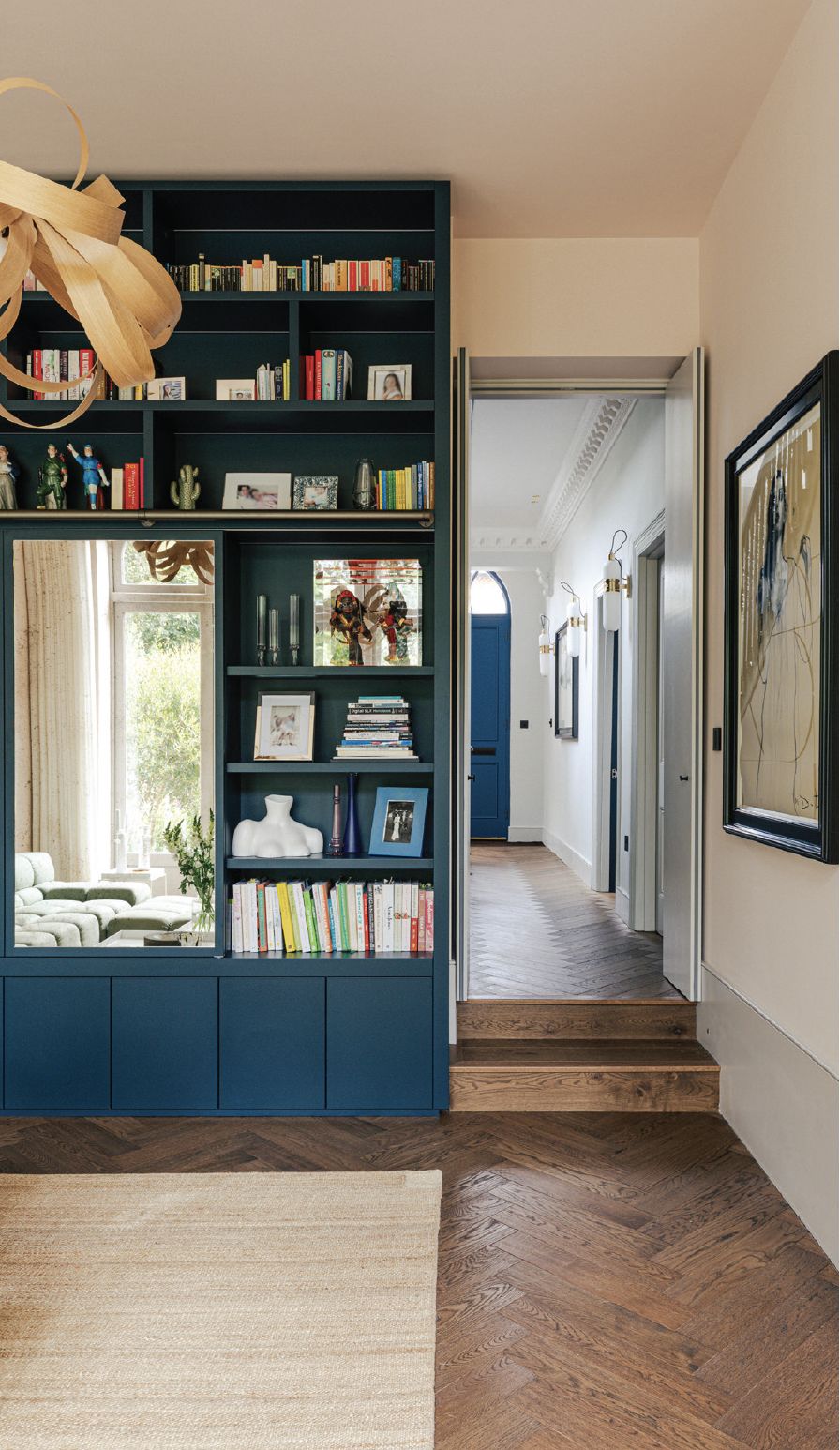 The shelf in the living room, featuring an antique mirror that houses the television