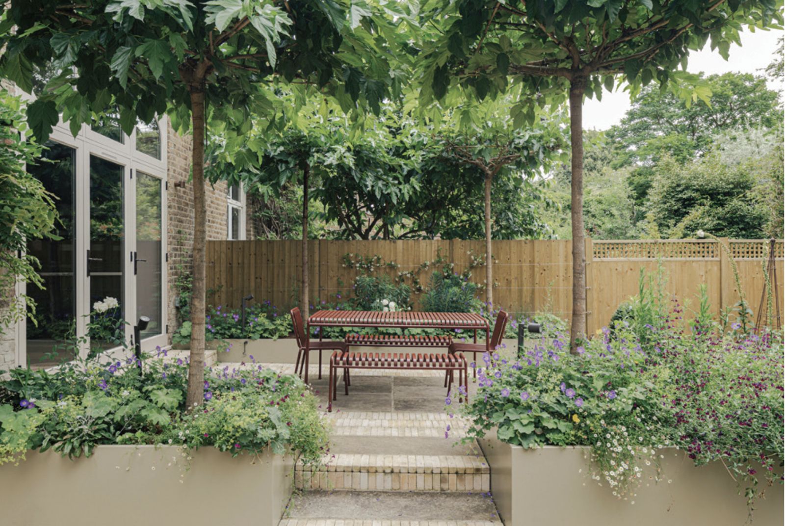 The dining patio area under a canopy of mulberry trees