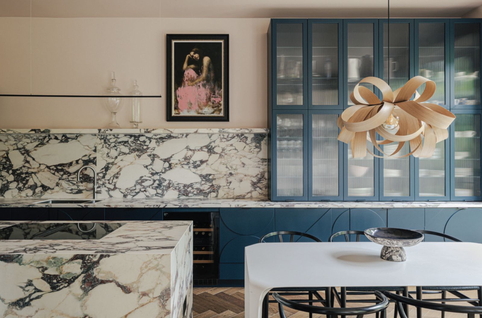 The kitchen's marble backsplash and island near the dining table