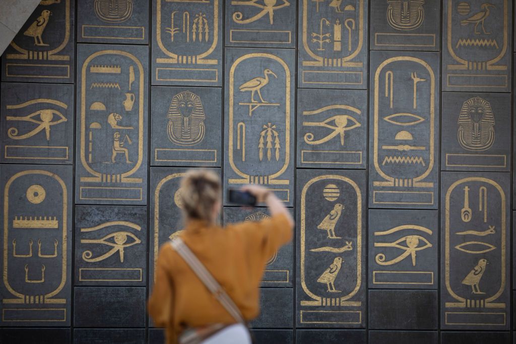15 October 2024, Egypt, Giza: A visitor takes pictures of the entrance to the Grand Egyptian Museum (GEM) in Giza. A partial soft opening of the Grand Egyptian Museum will start on Wednesday, October 16, with a trial operation for the museum's main hall and a gradual operation of some other sections in preparation for the grand official opening. Photo: Gehad Hamdy/dpa (Photo by Gehad Hamdy/picture alliance via Getty Images)