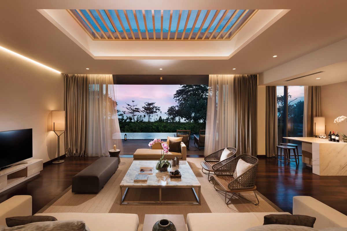 The living room of Anantara Desaru Coast Residences’ four-bedroom villa opens up to the private pool