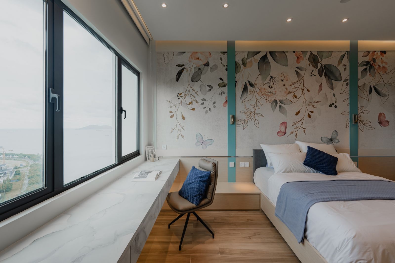 Coastal Chinoiserie wallpapers are featured throughout the unit