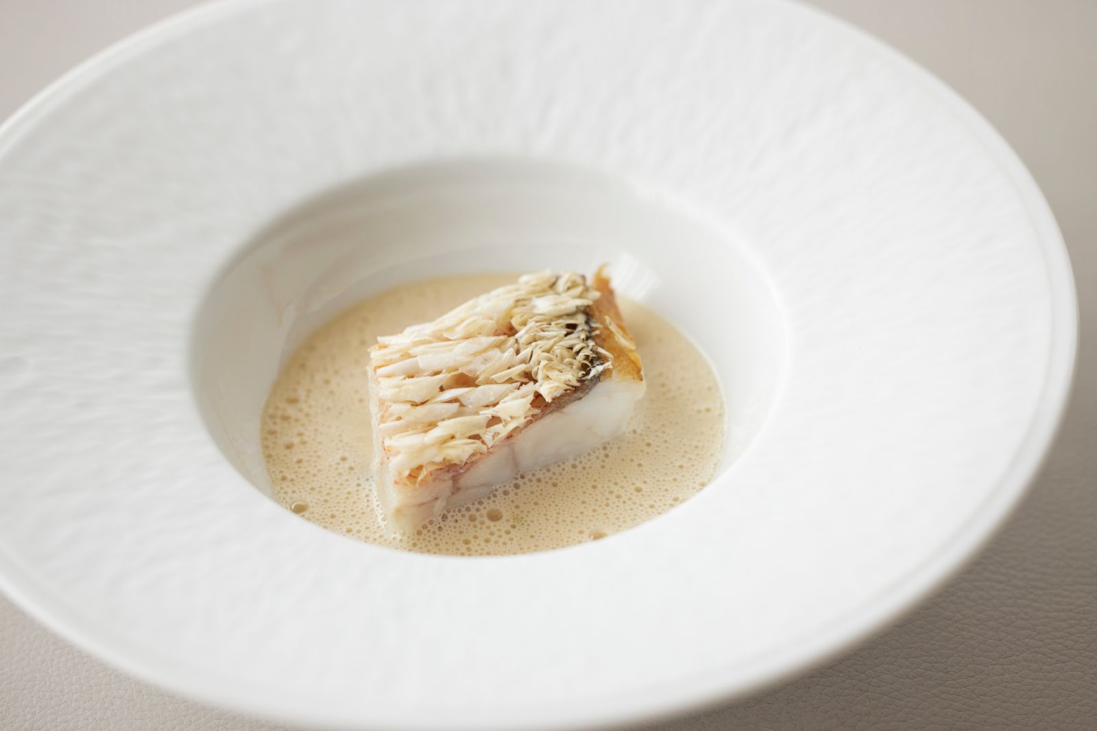 Crispy skin amadai from Yamaguchi with shin tama negi and sake-kasu at Sézanne