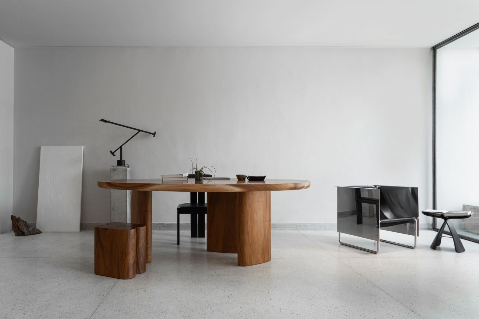 The large, custom-made solid wood table and mirrored armchairs were designed by the studio