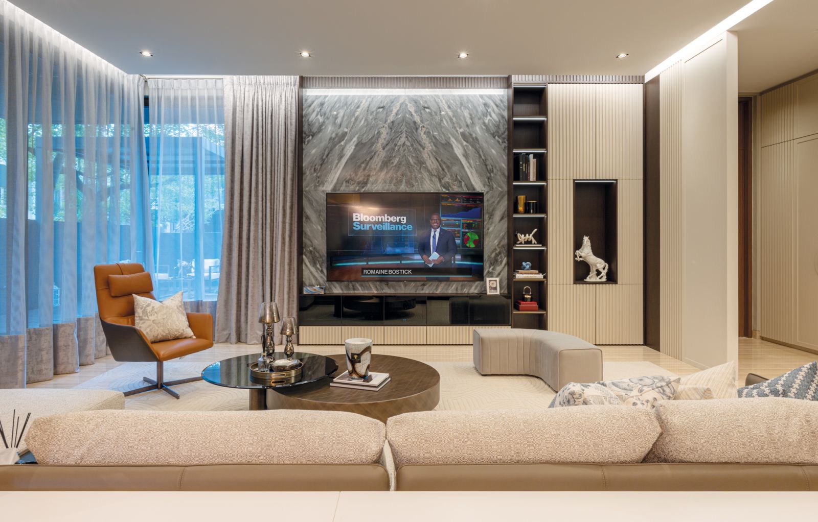 This marble feature wall brings a dramatic air to the sedate living room
