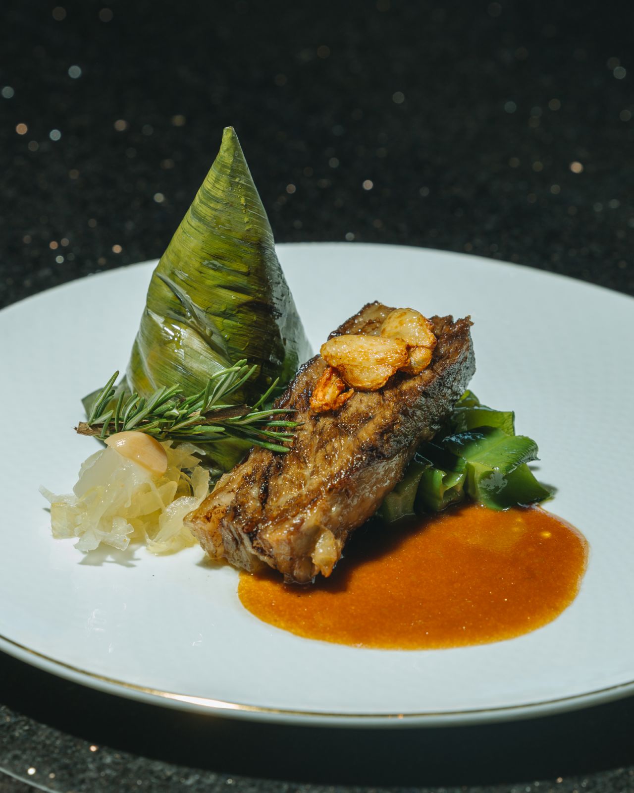 Braised and grilled Angus short rib adobo white balsamico adobo jus, papaya and nata de coco atchara, heirloom brown rice sinangang ang dried mango in banana leaf cones, kalabasa flowers and sigarilyas guisado by Margarita Forés