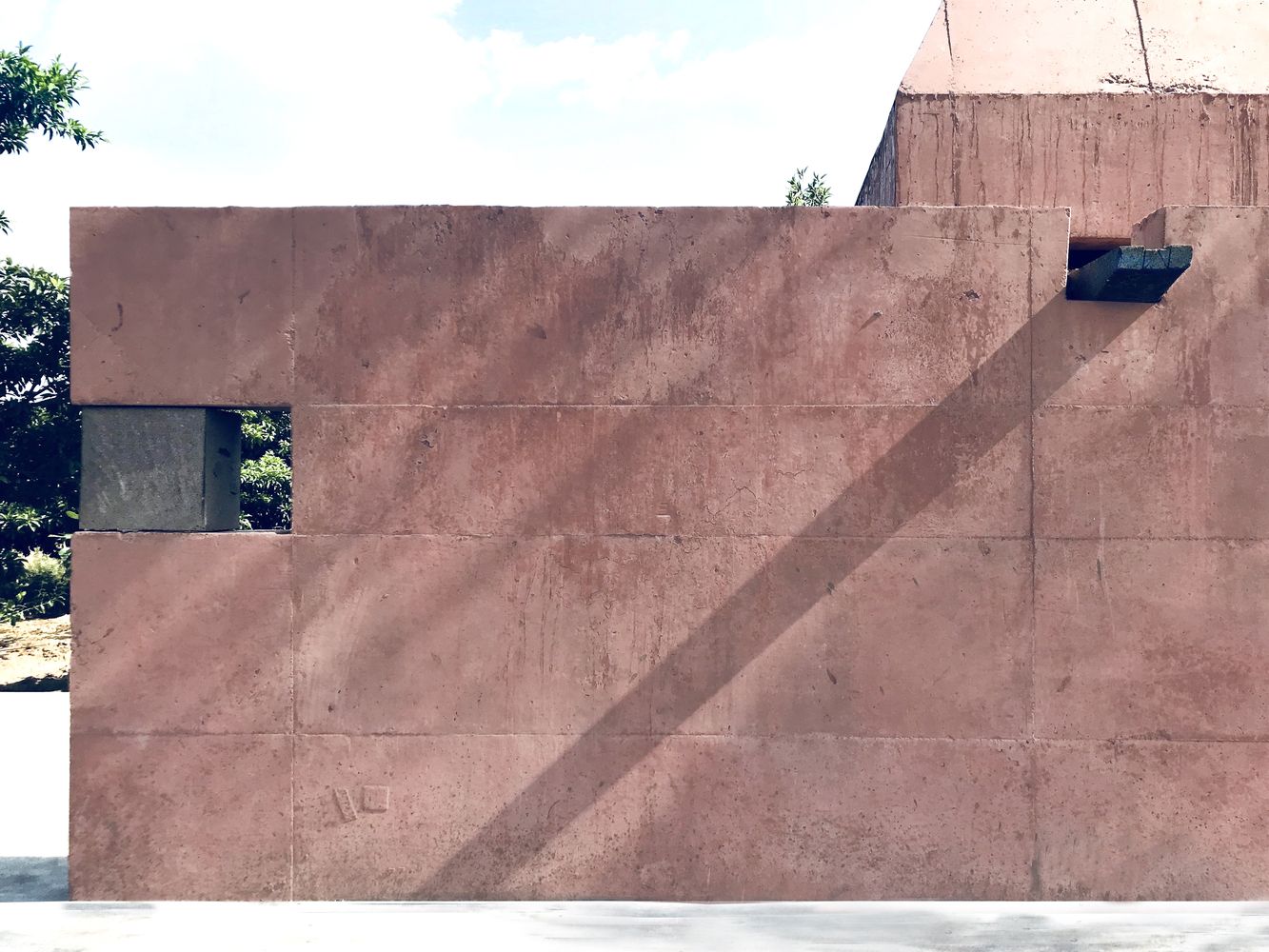 The reddish-orange concrete creates a striking contrast against its verdant surroundings (Photo: Instagram / @atmosphere__space)