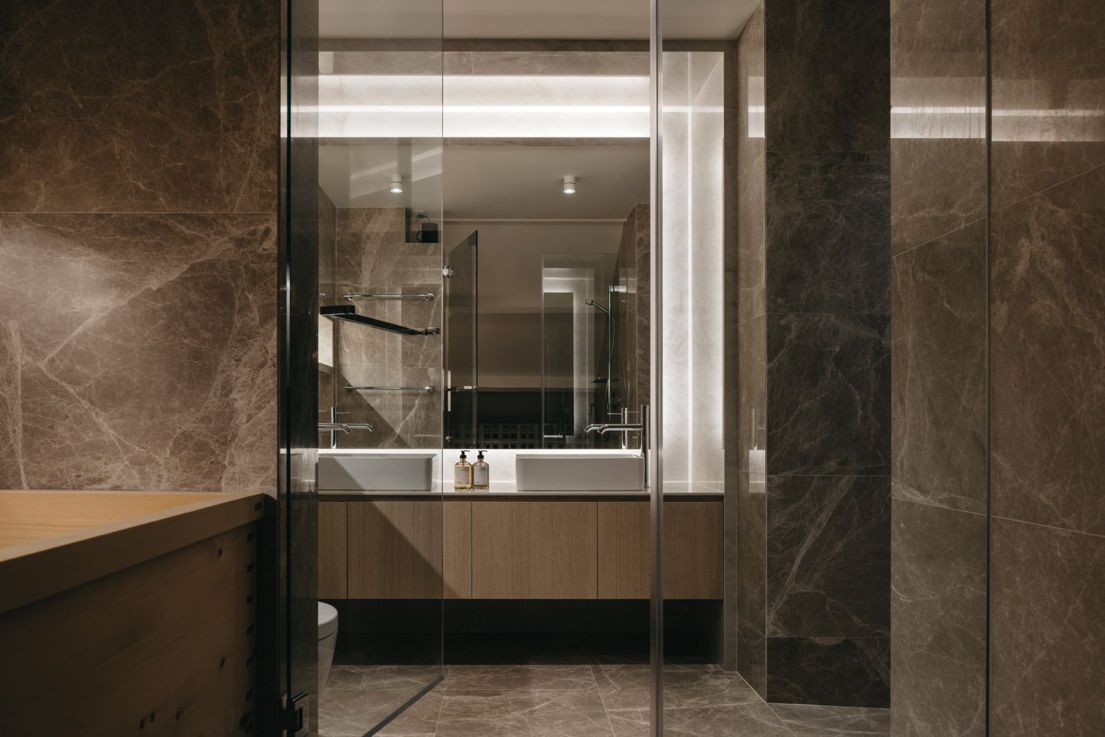 The stately bathroom features a Hinoki wood bathtub and elegant stone finishes
