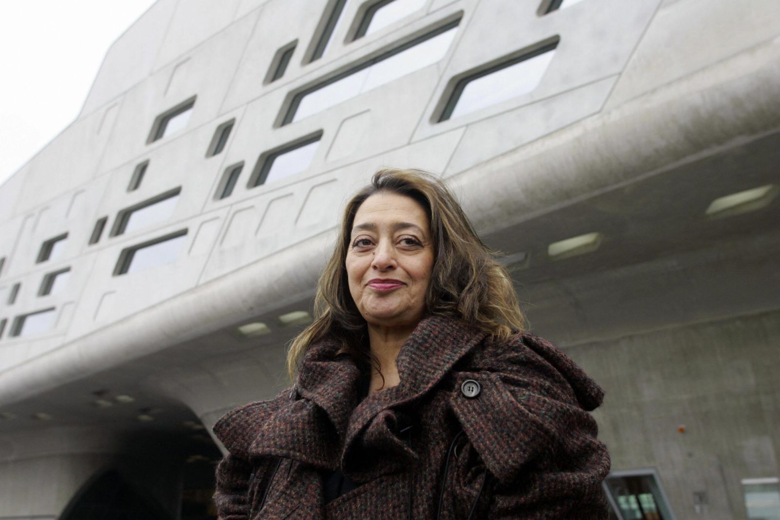 WOLFSBURG, Germany: Iraqi-born London-based architect Zaha Hadid poses in front of the building housing the "Phaeno" Science Center and museum in Wolfsburg 23 November 2005. The building, which has 9.000 square meters of exhibition space, will house a science center where people will be able to "experience" scientific experiments. The center, built at a cost of EUR 80 million, will be inaugurated 25 November 2005. AFP PHOTO DDP/JOCHEN LUEBKE GERMANY OUT (Photo credit should read JOCHEN LUEBKE/DDP/AFP