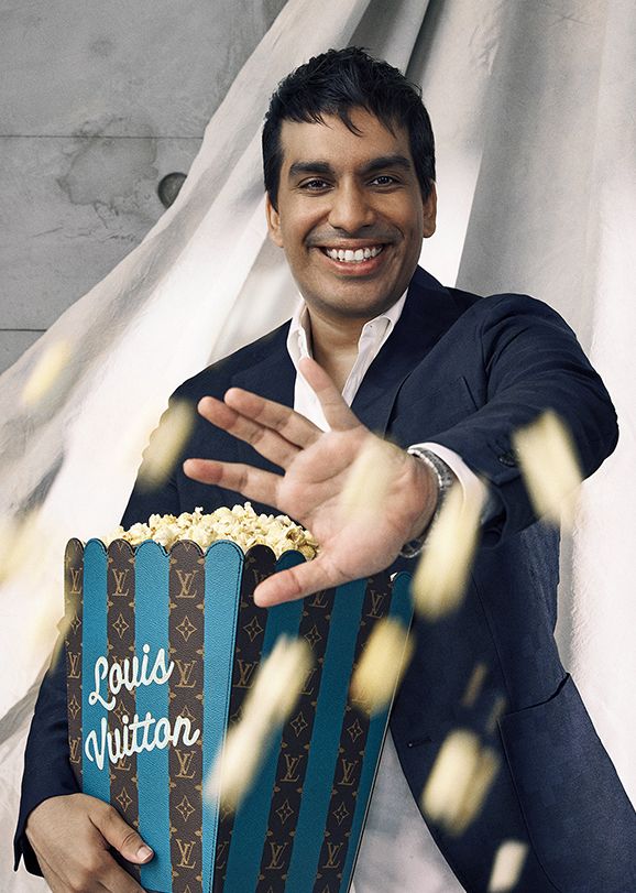Balasingam wears Louis Vuitton jacket, shirt, a Tambour Automatic 40 mm watch in steel,and holds a Louis Vuitton Pop Corn Basket GM