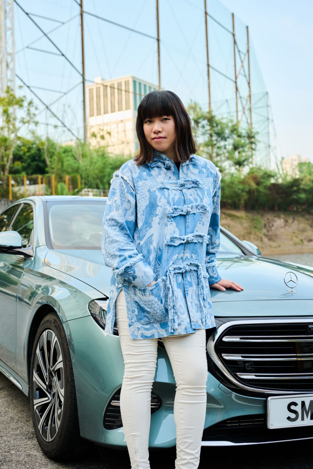 Li poses in front of the Mercedes-Benz E-Class W204 outside of Hong Kong Stadium in Causeway Bay (Photo: Zed Leets/Tatler Hong Kong)