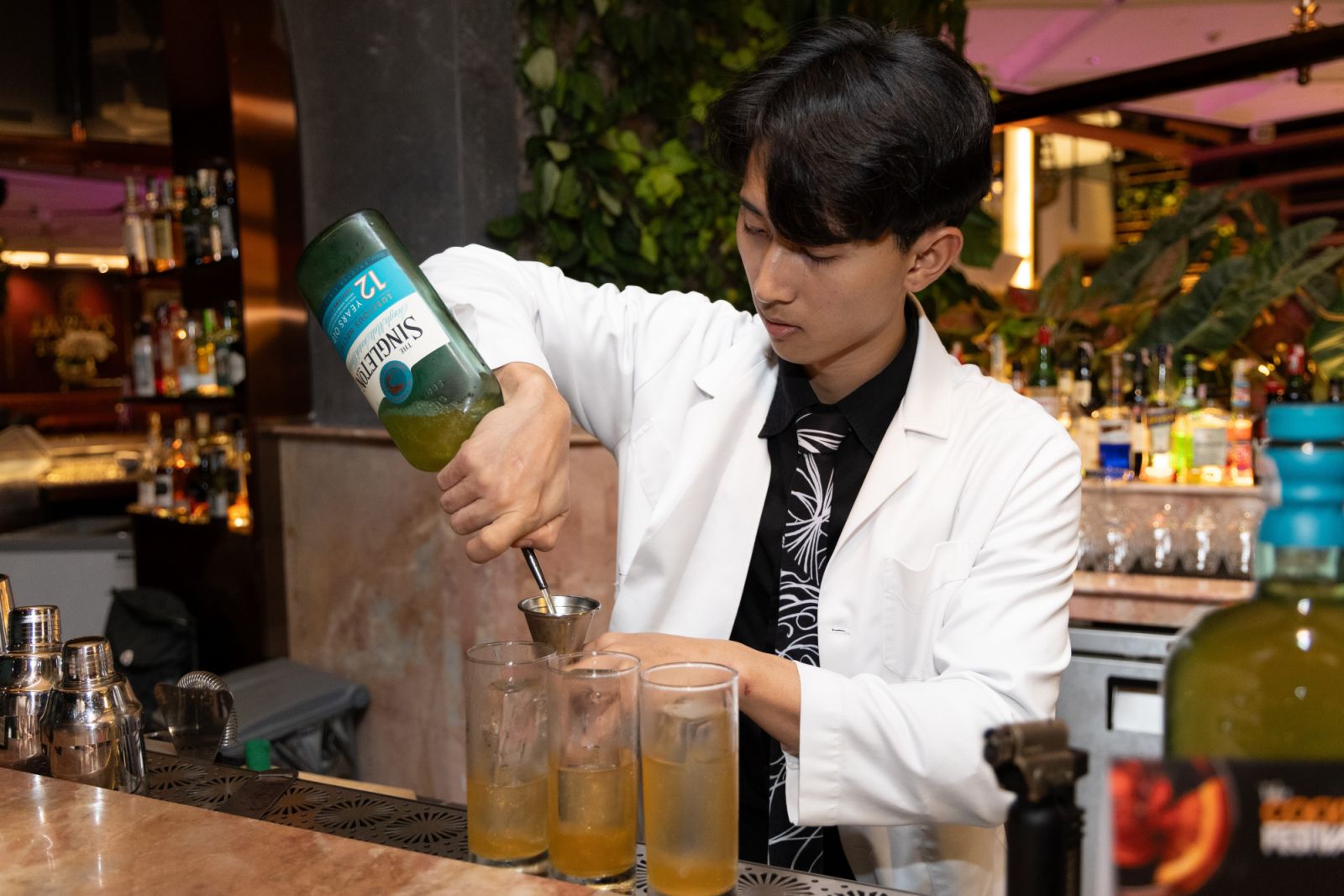 Pollen Bar’s mixologist crafting the exclusive ‘Raynue Tatler Elixirs’ featuring The Singleton of Dufftown, at Tatler Cocktail Festival