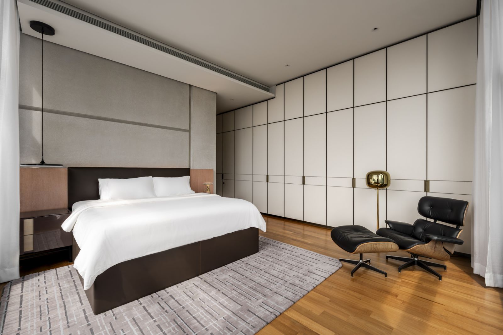 The master bedroom features a meticulously detailed wall panel