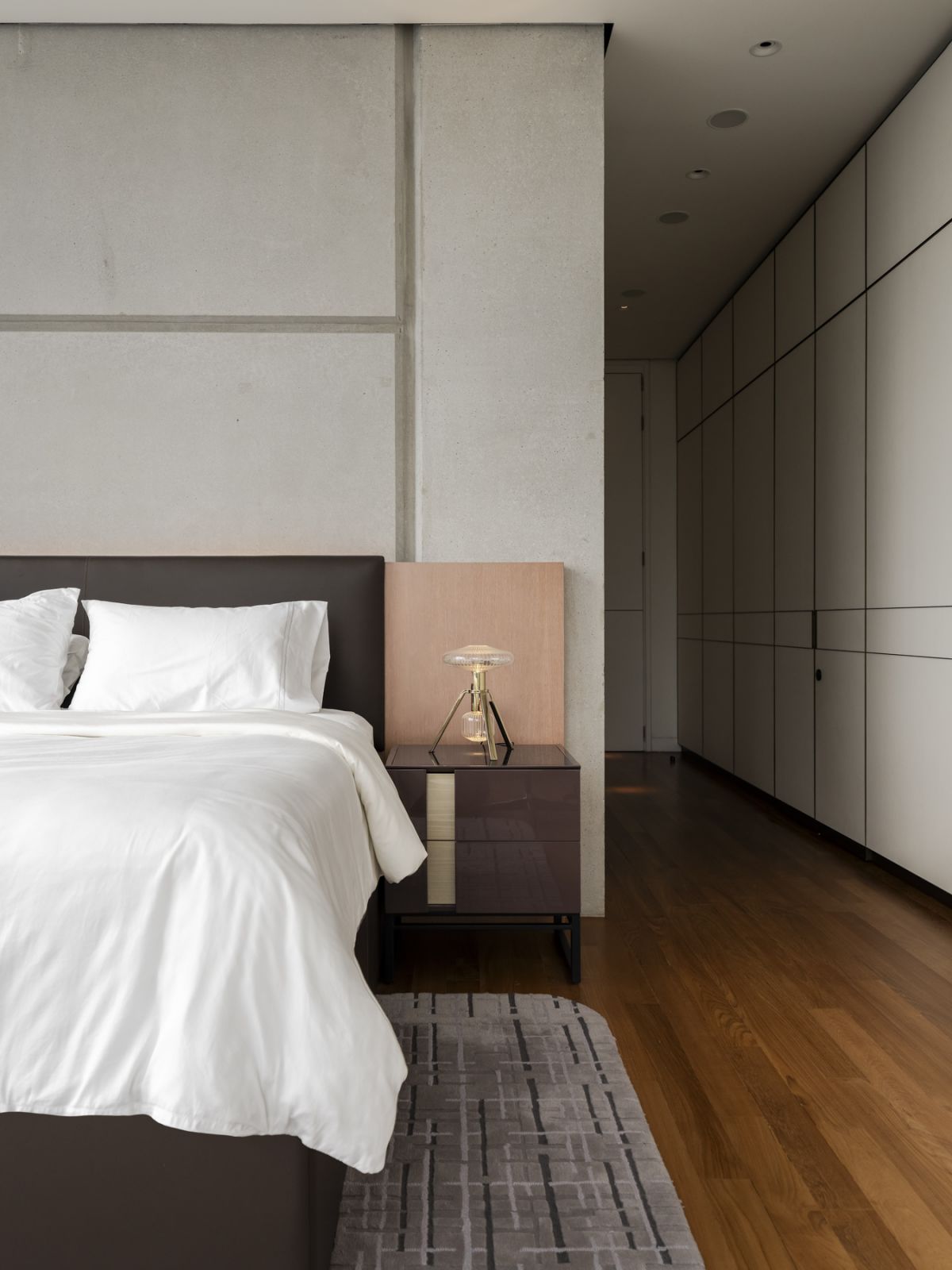 The master bedroom features a meticulously detailed wall panel