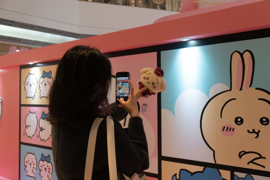 SHANGHAI, CHINA - MARCH 31, 2024 - Young people buy Chiikawa dolls of various sizes and derivatives at MINISO X Chiikawa themed pop-up shop in Shanghai, China, March 31, 2024. (Photo credit should read CFOTO/Future Publishing via Getty Images)
