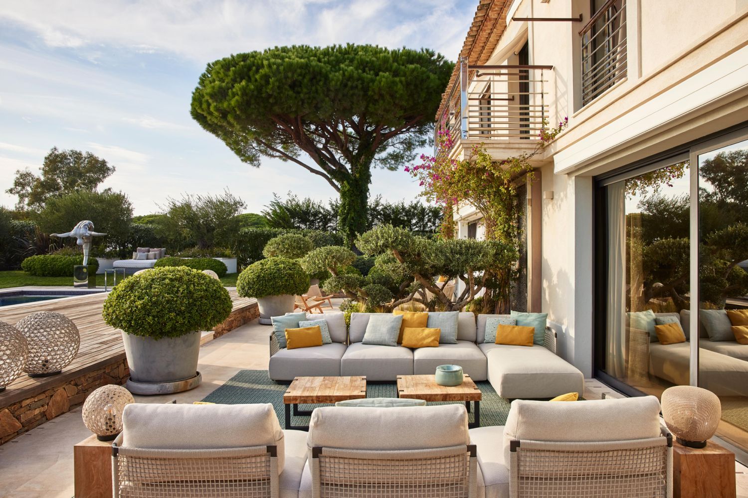 Two lounge spaces separated by an olive tree (Photo: Francis Amiand)