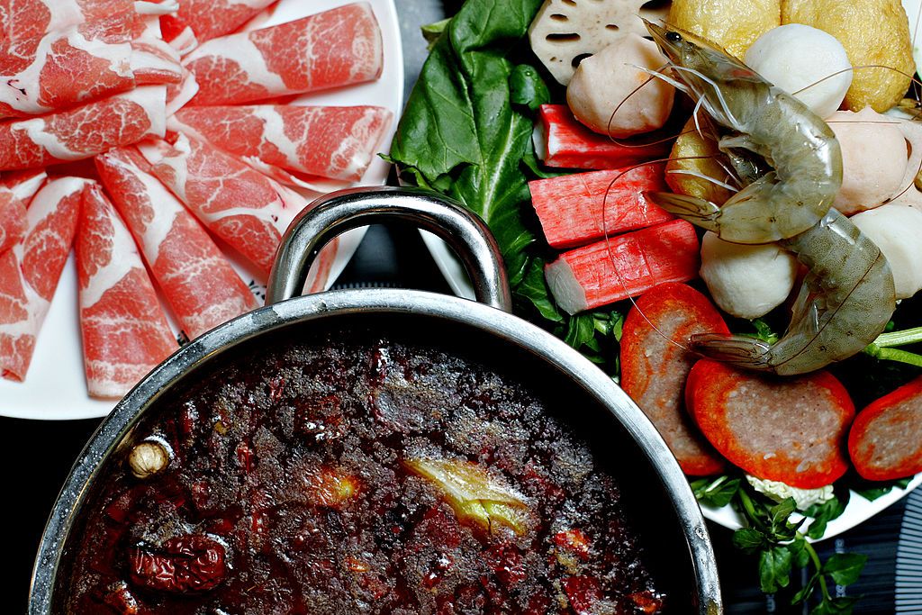 MONGOLIAN HOT POT--02/27/07--Small Yin Yang (Spicy & Chicken) hot pot with a sample plate of assorted veggies, meats and seafood to add. Mongolian Hot Pot restaurant for review by Linda Nguyen. February 27, 2007. (Tara Walton/Toronto Star) (Photo by Tara Walton/Toronto Star via Getty Images)