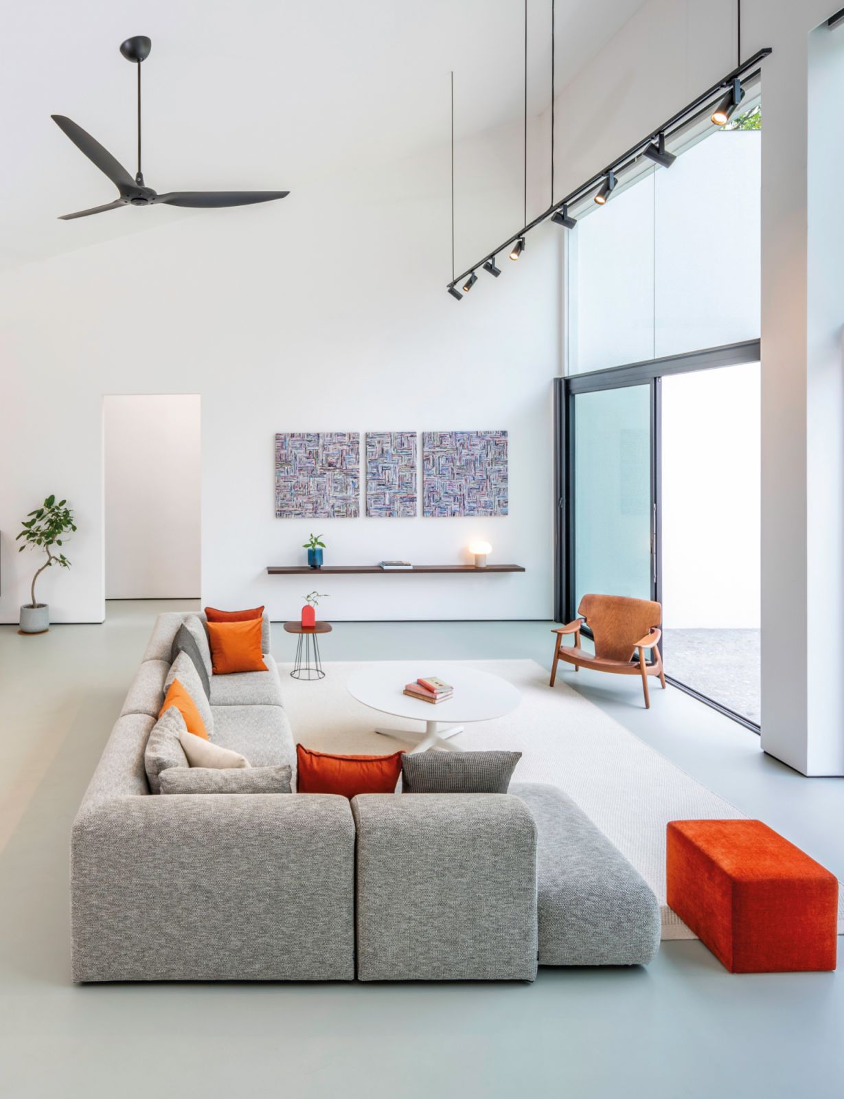The living room is a well-composed tableau of soothing colours and textures