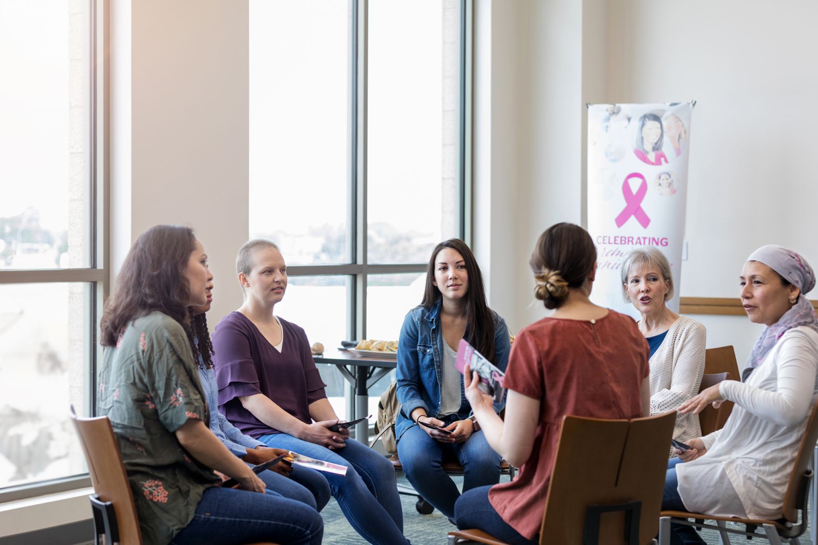 A group of women that have had their lives impacted by breast cancer meet to talk