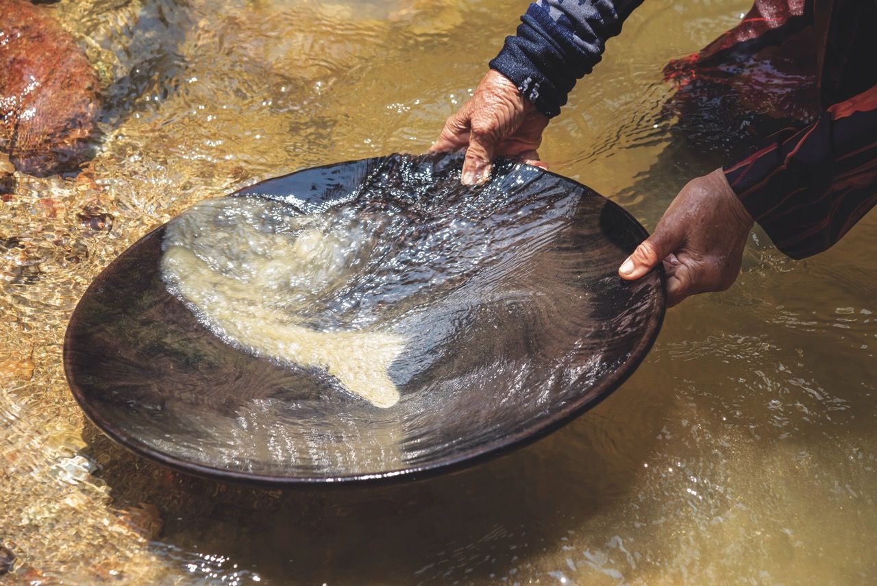 Gold panning, or simply panning, is a form of placer mining and traditional mining that extracts gold from a placer deposit using a pan.