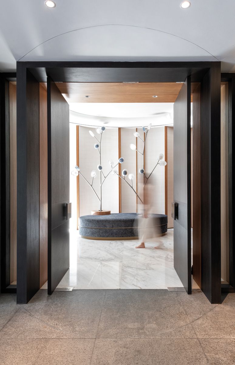 A custom oval bench with Bocci light installations welcomes visitors at the basement entrance