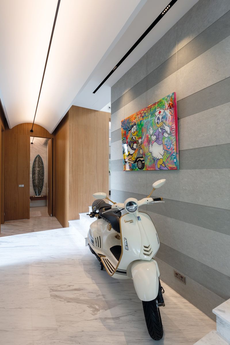 The Dior Vespa parked in the lift corridor sets a playful tone