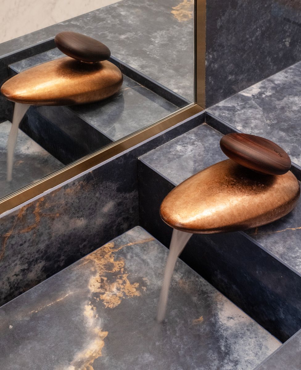 The pebble-like Gessi tap and natural stone washbasin lend a touch of luxe to bathroom