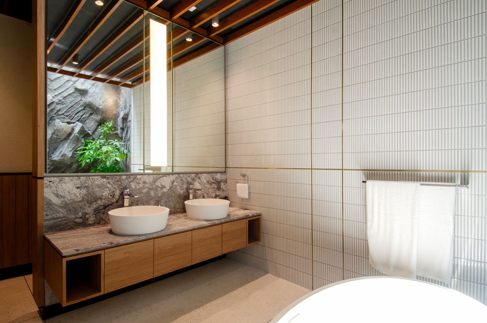 A functional bathroom layout that maximises space with essential elements conveniently positioned (Photo: Rupajiwa Studio)