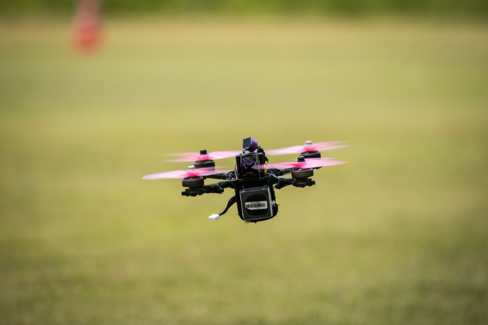 Racing drone flying over the practice field