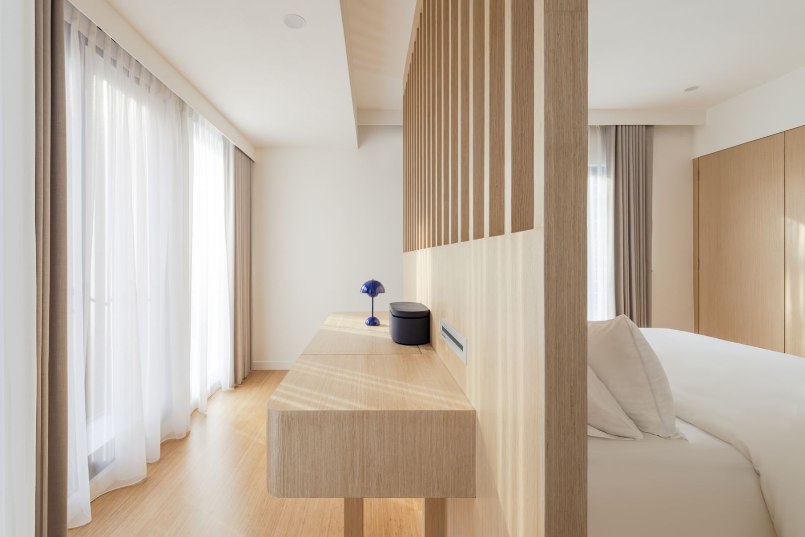 A minimalist desk area in the bedroom showcases the architect’s attention to detail