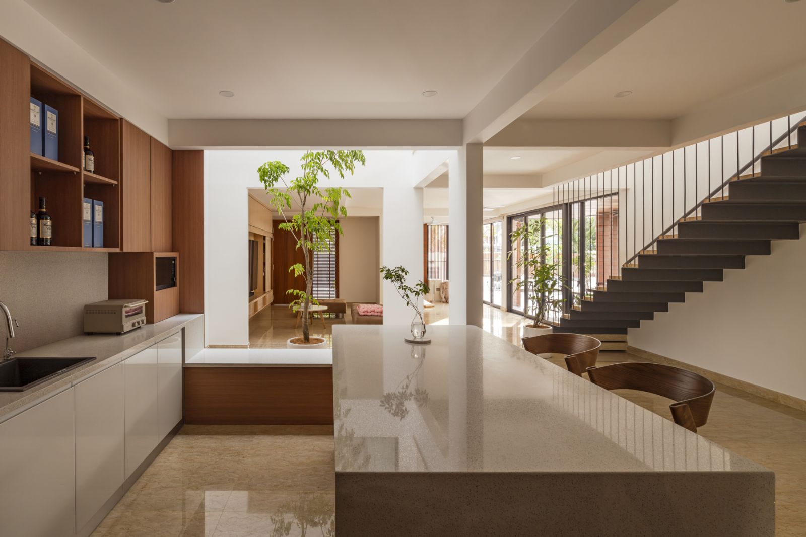 The open-plan kitchen and living area centers around a frameless skylight that floods the space with natural light