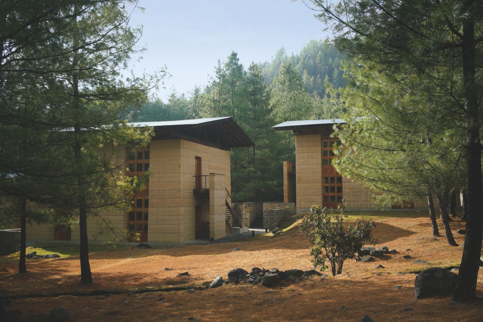 Suites exterior next to brooks and pine forest at Amankora Paro