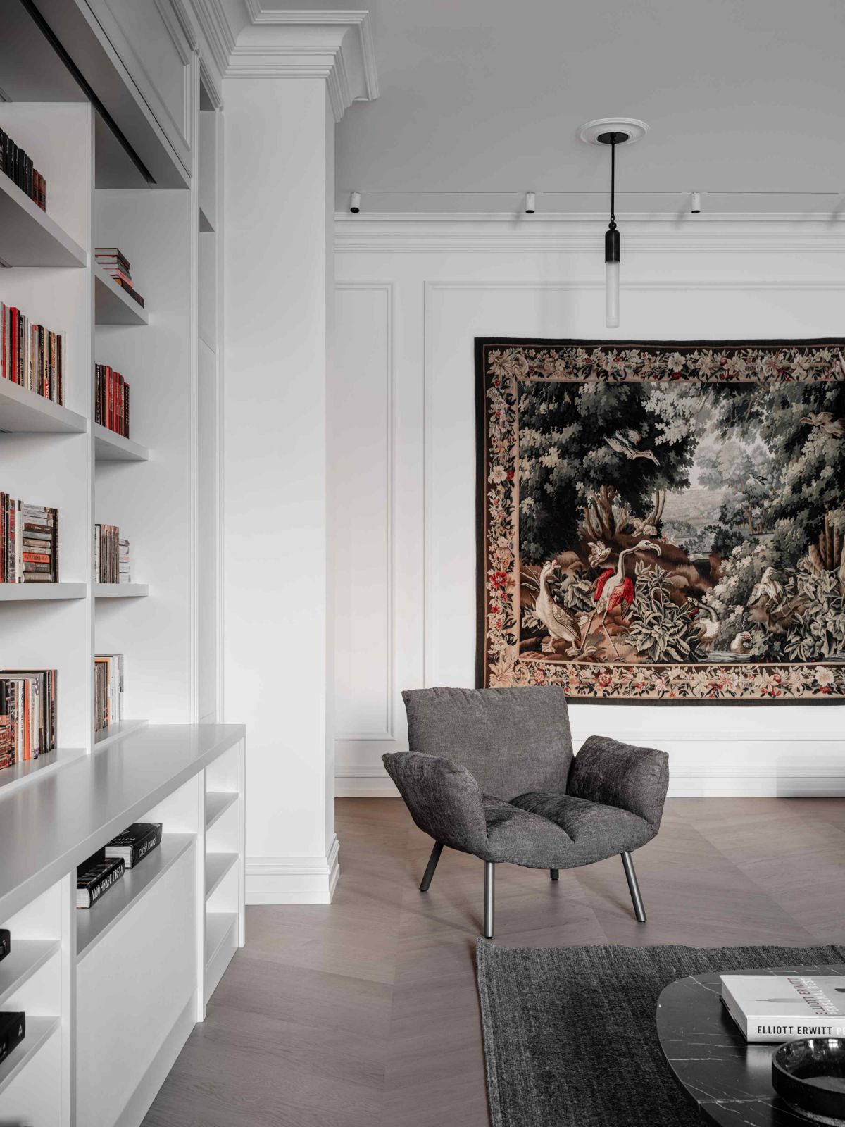 An antique tapestry from Mark Patlis Studio provides a vibrant backdrop to the Bonaldo armchair