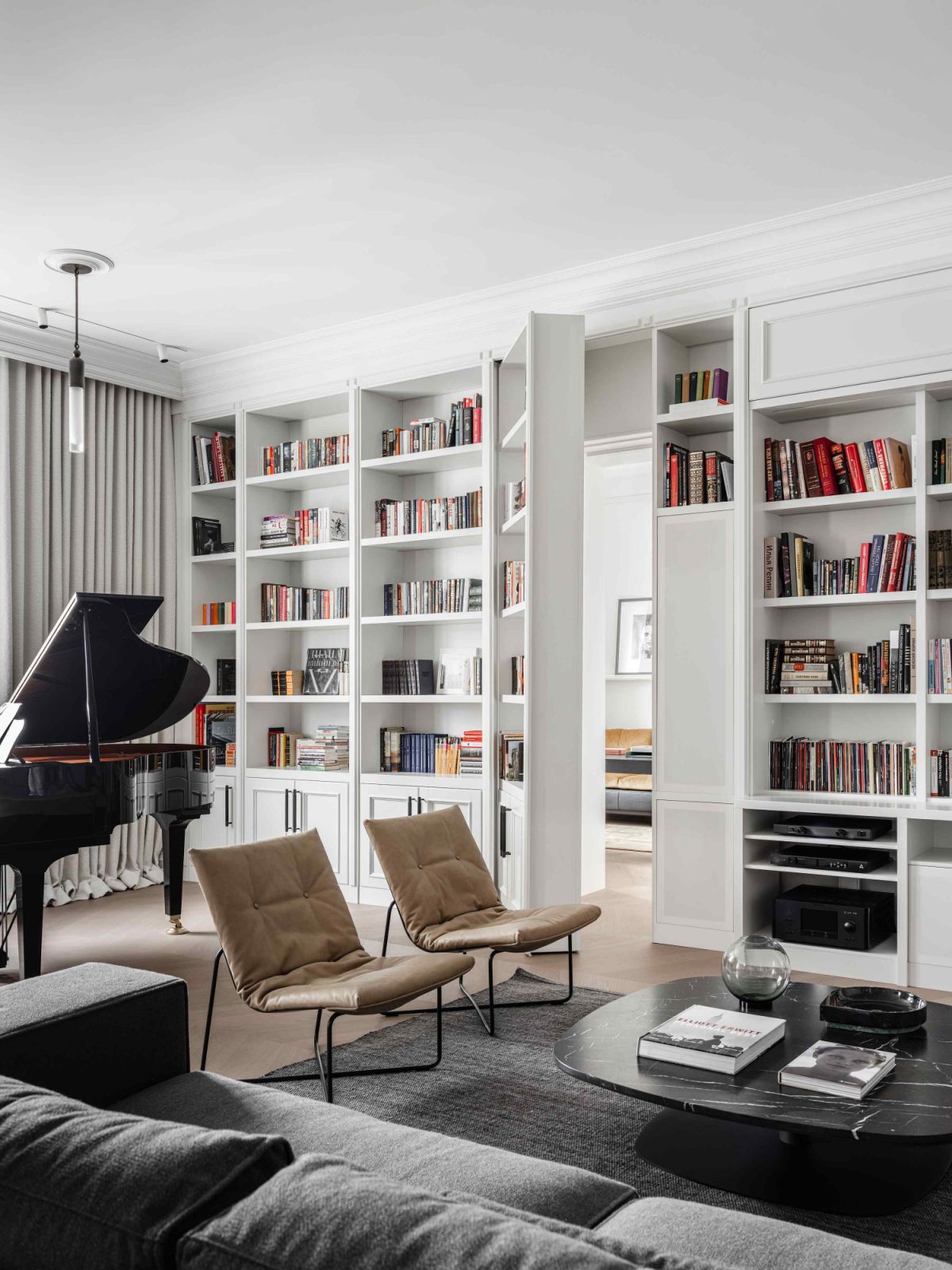 A hidden door behind the bookshelf leads into the home office