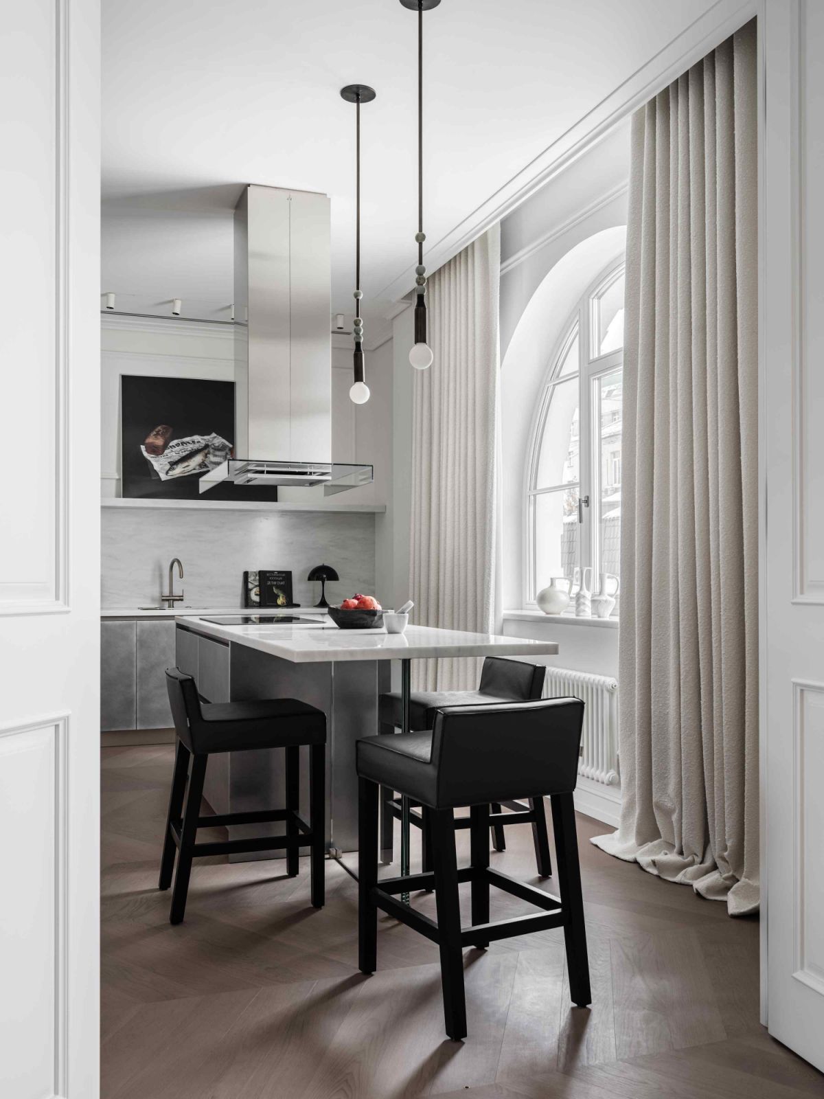 The sleek kitchen area with gracefully arched windows