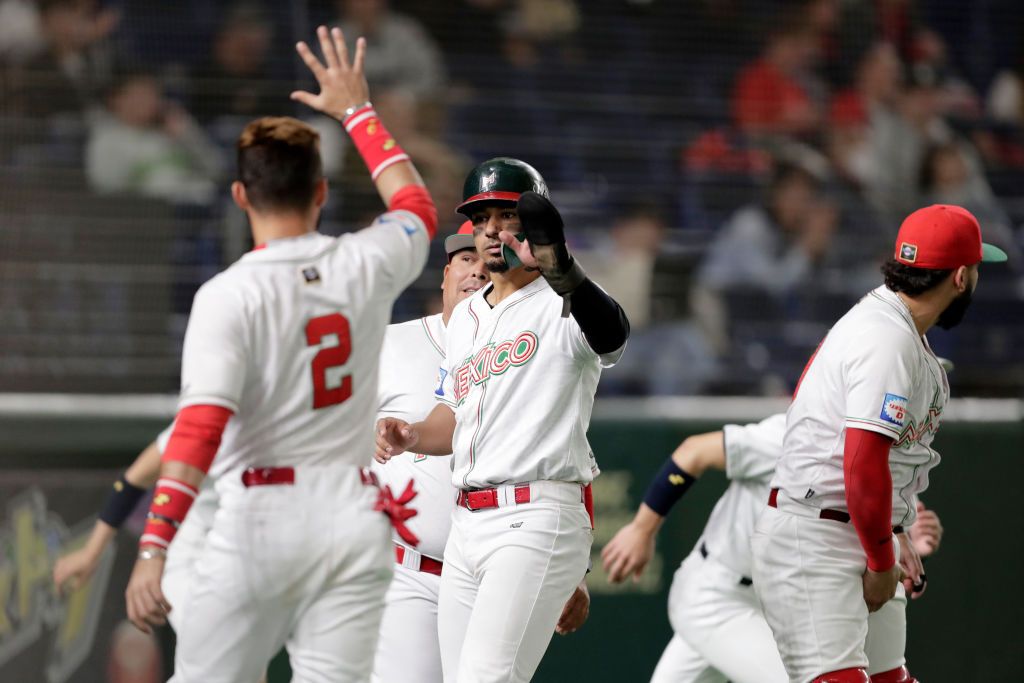 TOKYO, JAPAN - NOVEMBER 17: Outfielder Jonathan Jones (C) #27 of Mexico celebrates after scoring a run by a RBI single of Designated hitter Matthew Clark #31 in the bottom of 6th inning during the WBSC Premier 12 Bronze Medal final game between Mexico and USA at the Tokyo Dome on November 17, 2019 in Tokyo, Japan. (Photo by Kiyoshi Ota/Getty Images)