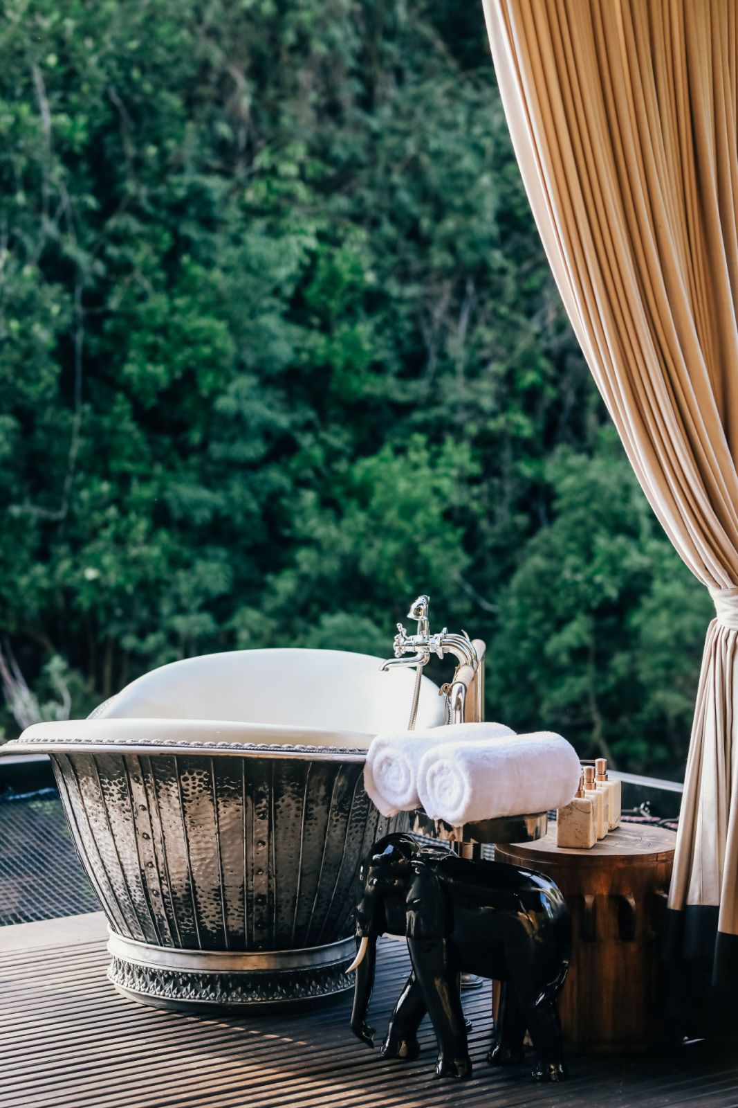 Tents outdoor deck with riverside tub at Shinta Mani Wild