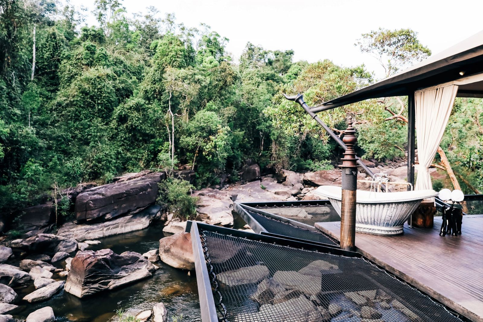 Tent outdoor deck with riverside tub at Shinta Mani Wild