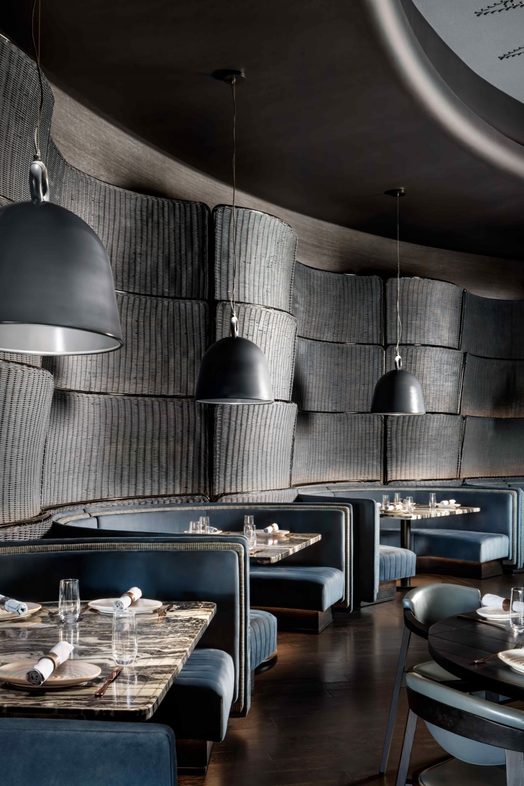 The main dining area in a moody cobalt-blue and grey palette