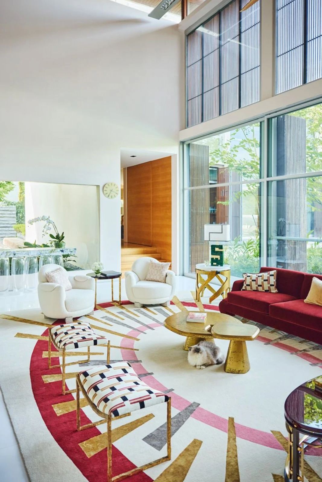 The homeowners share their homes with four cats, one of which is the ragdoll that accompanied our shoot, seen here lounging beneath coffee tables from Invisible Collection