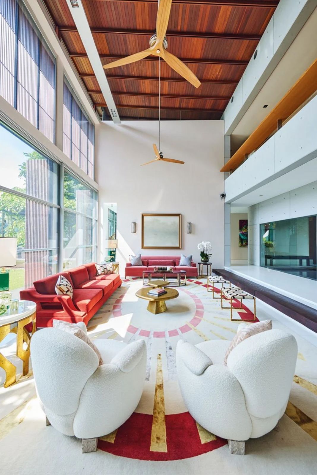 The Good Class Bungalow’s double-height living room features a striking sunset-inspired palette and a geometric rug symbolising the sun’s rays
