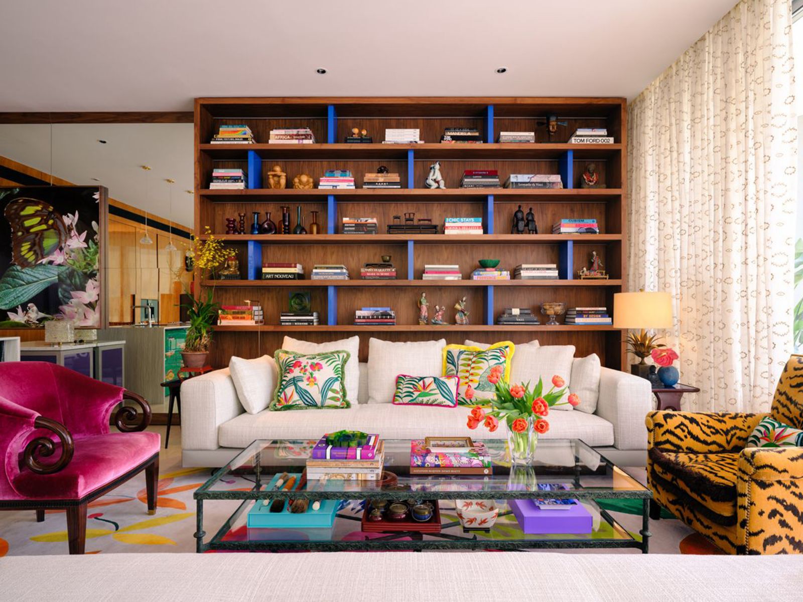 Blue dividers break up the uniformity of these wooden display shelves in this sitting area