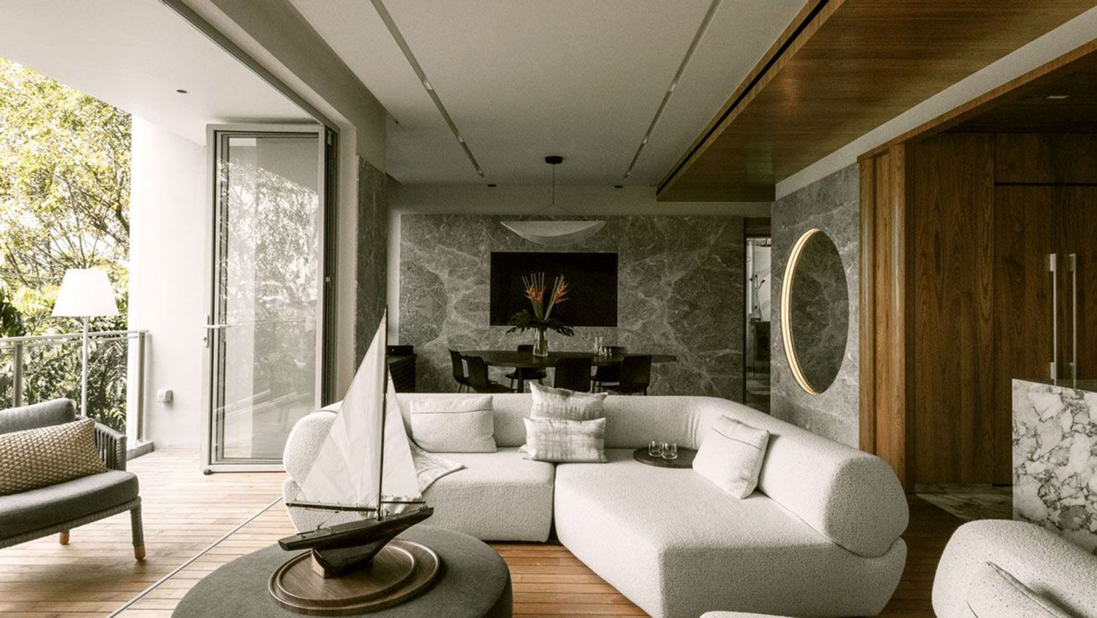 The home’s grand open-plan living area designed by Architology Interiors features teakwood flooring designed in the style of a yacht deck
