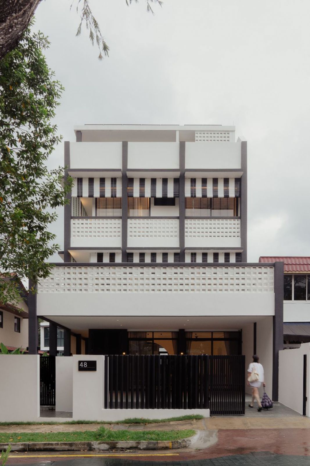 The exterior of this terrace house mirrors the design language of the colonial-era black-and-white bungalows in Singapore