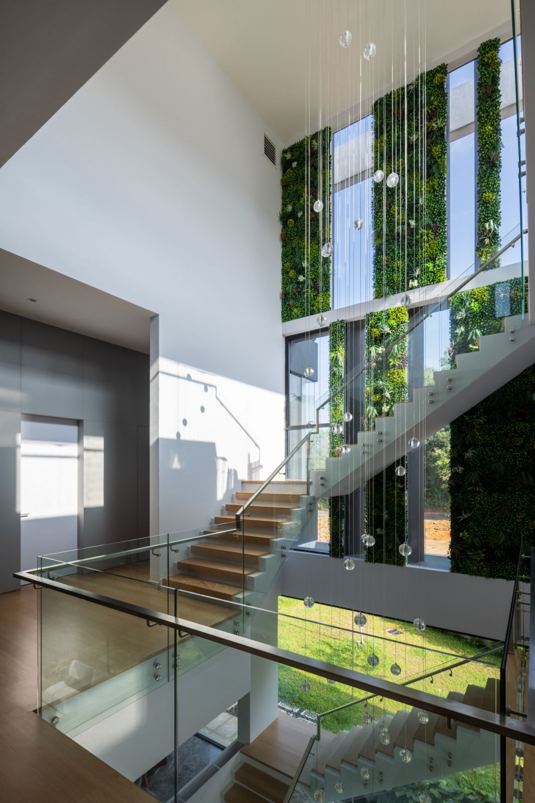 The floating staircase pierces through the heart of the home