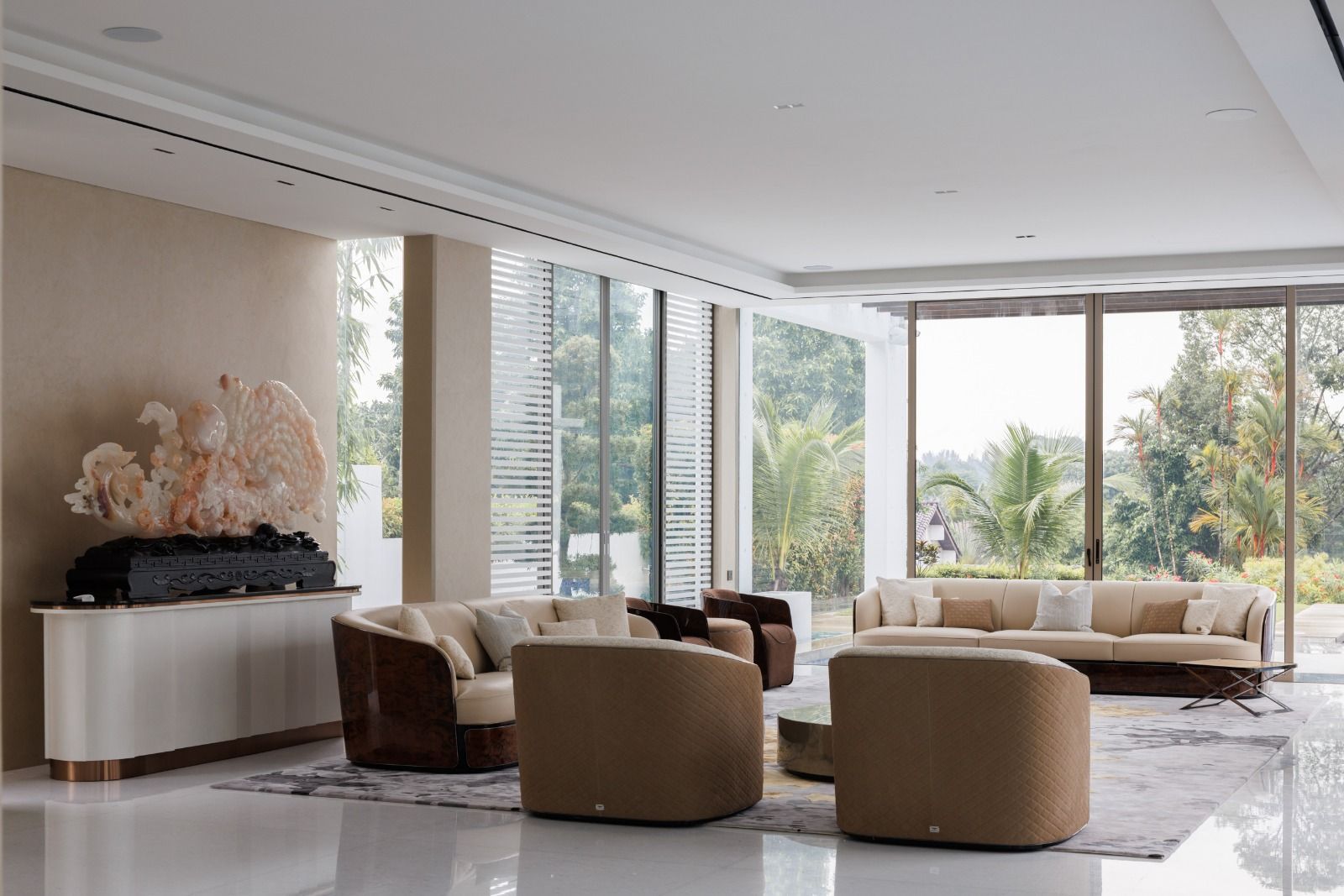The living room in this Bukit Timah Good Class Bungalow is furnished with Bentley Bampton sofas and armchairs, and a Meridiani Belt coffee table