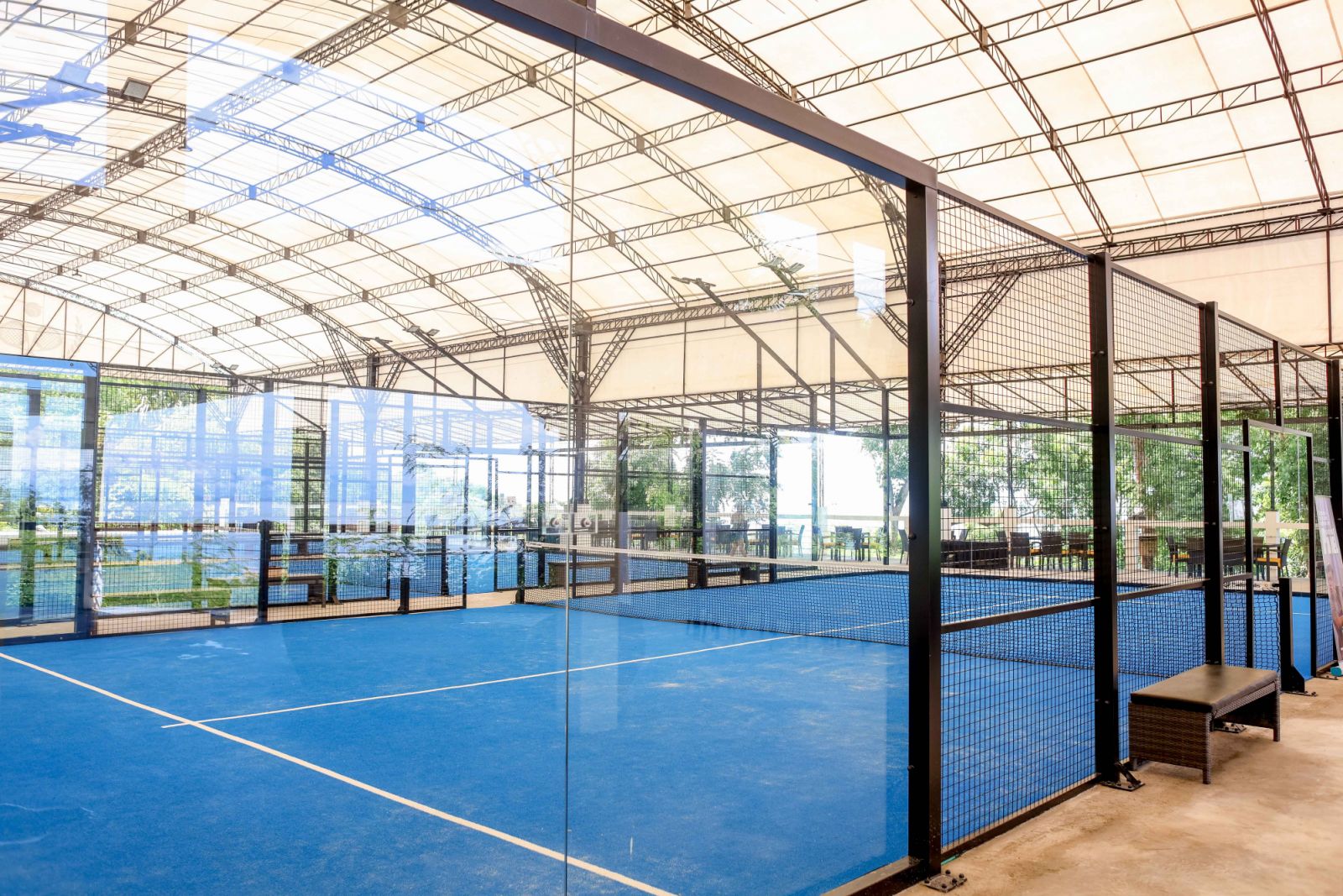 Padel courts are surrounded by walls, typically made of glass and fencing (Photo: Steph Naval)
